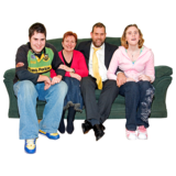 Four people sitting on a couch together